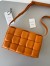 Bottega Veneta Padded Cassette Bag In Orange Intrecciato Lambskin